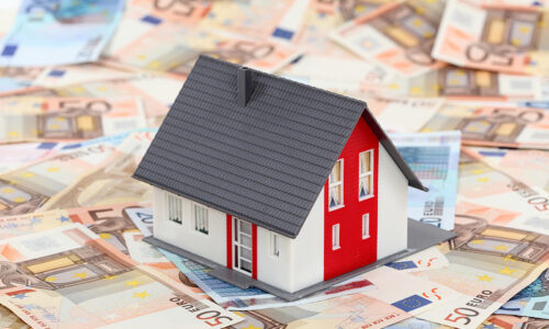 Model house placed on euro banknotes background